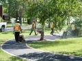 The Superior Asphalt team smoothing out a new walkway in Winnipeg