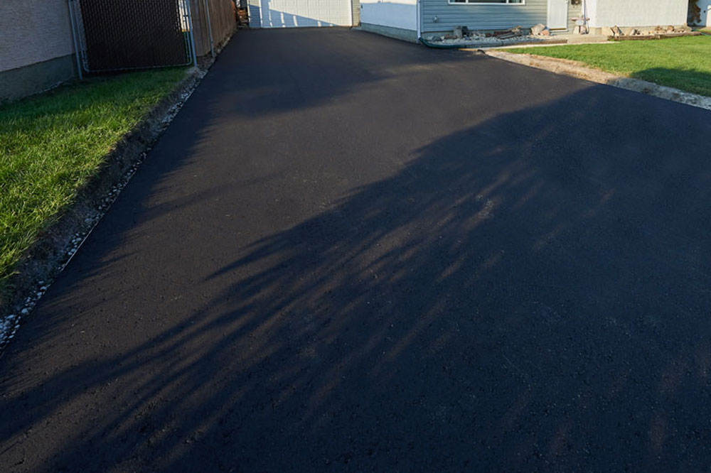 A new, sealed driveway paved by Superior Asphalt in Winnipeg