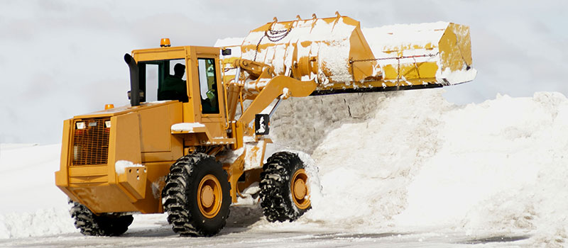Clearing snow in a commercial parking lot in Winnipeg