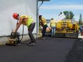 Fresh asphalt is smoothed on a new driveway in Winnipeg