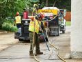 The Superior Asphalt team uses heat to cure the crack sealant on a driveway