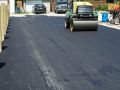 Fresh asphalt cools and hardens on a new road in Winnipeg