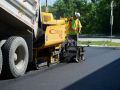 A Superior Asphalt team member applying new asphalt to a parking lot in Winnipeg