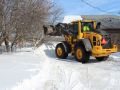A Superior Asphalt team member clears a driveway in Winnipeg